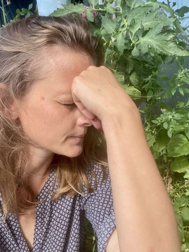 Gunhild stützt wütend den Kopf in die Hand